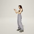 A Woman Wearing Brown Crop Top and Gray Pants Holding Glasses in Light Colored Background