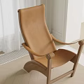 Modern Brown Leather Armchair With Wooden Frame In Bright Room With Wooden Floor