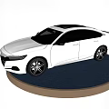 Modern White Sedan Car Featuring Sleek Exterior And Alloy Wheels On Display Stand