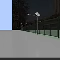 School Playground With Green Chain Link Fence Solar Street Lights Sidewalk And Blue Sky