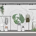 Stylish Fashion Clothing Store Window Display With Mannequins Green Plants Statues And Lighting Accents
