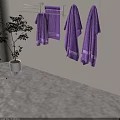 Purple Towels Hanging on Metal Rack with Green Potted Plant Indoor