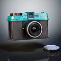 Vintage Digital Camera With Turquoise Top And Black Body Featuring Classic Lens And Cap