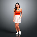 Woman in Orange Tank Top White Skirt and White Shoes Standing Against Gray Background
