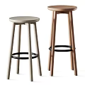 Two Modern Bar Stools With Round Seats And Metal Foot Rests In Different Colors