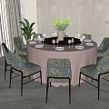 Elegant Round Dining Table With Pink Tablecloth And Blue Floral Upholstered Chairs