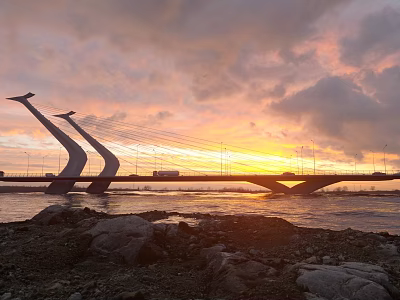 Modern Cable Stayed Bridge With Sunset Sky Over River And Stone Shore 3d model