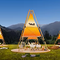 Scenic Camping Site with Triangle Tents CHILLS Logo and Mountain Backdrop