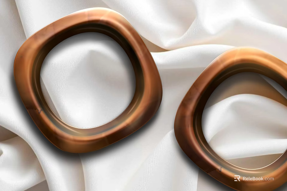 Elegant Copper Colored Hoop Jewelry Pieces Displayed On White Silk Fabric 3d model 