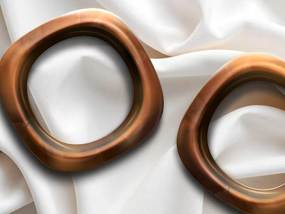 Elegant Copper Colored Hoop Jewelry Pieces Displayed On White Silk Fabric 3d model