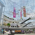 Modern Shopping Mall Interior With Glass Structure Escalators Hanging Banners Palm Trees And Busy Shoppers