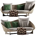 Curved Multi Person Sofa with Woven Frame Gray Cushions Green Pillows and Plaid Blanket