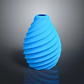 Green Leafy Plant in Blue Spiral Vase on Dark Reflective Surface