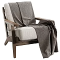 Comfortable Leisure Chair With Walnut Wooden Frame And Light Beige Fabric Cushion Draped Herringbone Blanket