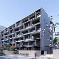 Modern Apartment Building Exterior With Balconies Cherry Blossom Trees And Blue Sky