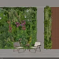 Lush Green Plant Wall with Large Leaves Pink Flowers and White Chairs in Indoor Space