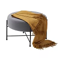 Stylish Gray Round Ottoman with Brown Fringed Blanket and Black Metal Legs