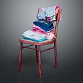 Colorful Stacked Clothes on Red Wooden Chair with T-shirts and Towels against Dark Background