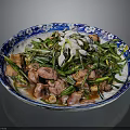 Chinese Traditional Dish On Blue And White Patterned Plate With Green Vegetables And Meat Pieces