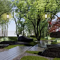 Natural Rockery Stones Landscape With Trees Hanging Lanterns Stone Slab Pathway And Rustic Cabin