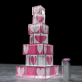 Transparent Cube Stacked Tower Art Installation With Pink Heart Patterns And Silver Device Purple Light