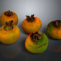 Five Fresh Persimmons With Yellow Orange And Green Hues On Dark Background