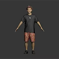 A Man in Black T shirt Red Patterned Shorts with Arms Outstretched Against Gray Background
