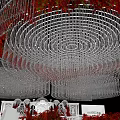 Elegant Wedding Banquet Hall With Crystal Chandelier Red Floral Decorations White Stage And White Chairs