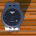 TISSOT Silver Watch With Black Dial Silver Strap On Wooden Floor Featuring Orange Brown Stripes
