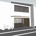 Modern Storefront Facade With White Wall Black Lattice Windows Brown Door Red Bicycle And Cactus