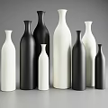 Black and White Ceramic Vases with Various Sizes and Shapes Arranged on Gray Background