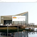 Waterfront Wooden Villa With Large Glass Windows Sloped Roof Wooden Deck And Water Reflection