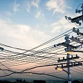 Road Infrastructure With Utility Poles And Power Lines Under Sunset Sky
