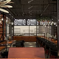 Industrial Restaurant Interior With Stone Wall Pendant Lights Wooden Tables Chairs Staircase And Plants