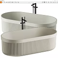 Two Modern Neutral Ribbed Freestanding Bathtubs With Black Faucets And Elegant Design