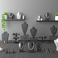 Jewelry Display Setup With Necklace Mannequins Earring Stands Green Plants And Shelves
