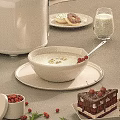 Creamy Dessert in White Bowl with Gold Leaf Red Berries Donuts Chocolate Cake and Milk