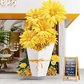 Event Entrance Decorated With Yellow Sunflowers And Chalkboard Sign For New Organic Menu