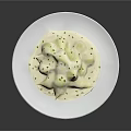 Creamy White Ravioli in Rich Sauce Garnished with Fresh Green Herbs on White Plate