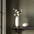 White Striped Vase with Pink Flowers Green Leaves and Short Round Vase on Dark Table