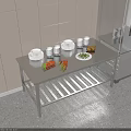 Stainless Steel Workbench In Commercial Kitchen With Plates Cups Carrots Potatoes And Vegetables