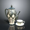 Decorative Ceramic Teapot With Intricate Patterns And Matching Teacup On Saucer