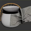 Cozy Rattan Chair with White Cushion Gray Geometric Pillow and Patterned Blanket