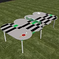 Outdoor Sports Equipment With Black And White Striped Connected Table Sections On Green Lawn
