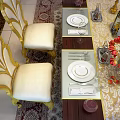 Luxurious Dining Table Set With Gold Accented Cream Seats Dark Wood Top And Red Tulips