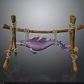 Purple and pink fish hanging on wooden structure made with sticks and ropes