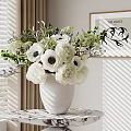 Decorative Ornament Set With White Flowers Dark Centers Green Plants White Vase And Marble Tabletop