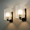 Modern Square Wall Lamps with Frosted Glass Shades and Black Brackets Illuminated on Beige Wall