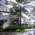 Modern Commercial Landscape With Lush Greenery Palm Trees Open Courtyard And Water Features