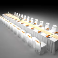 Elegant Banquet Table Setup With White Tablecloth Yellow Sashes And White Chairs